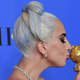 Lady Gaga embracing her Golden Globe in 2019.
